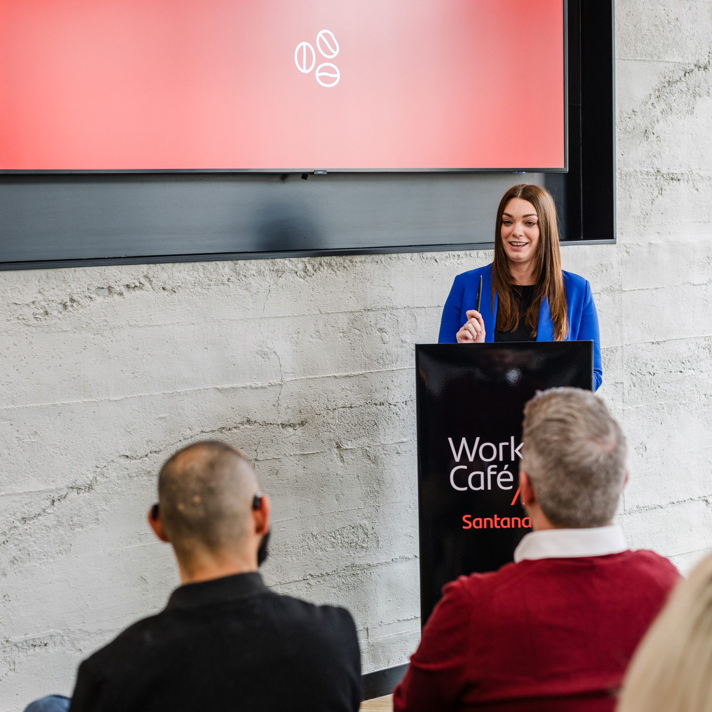 Lady presenting at lectern in IOM Work Cafe event space