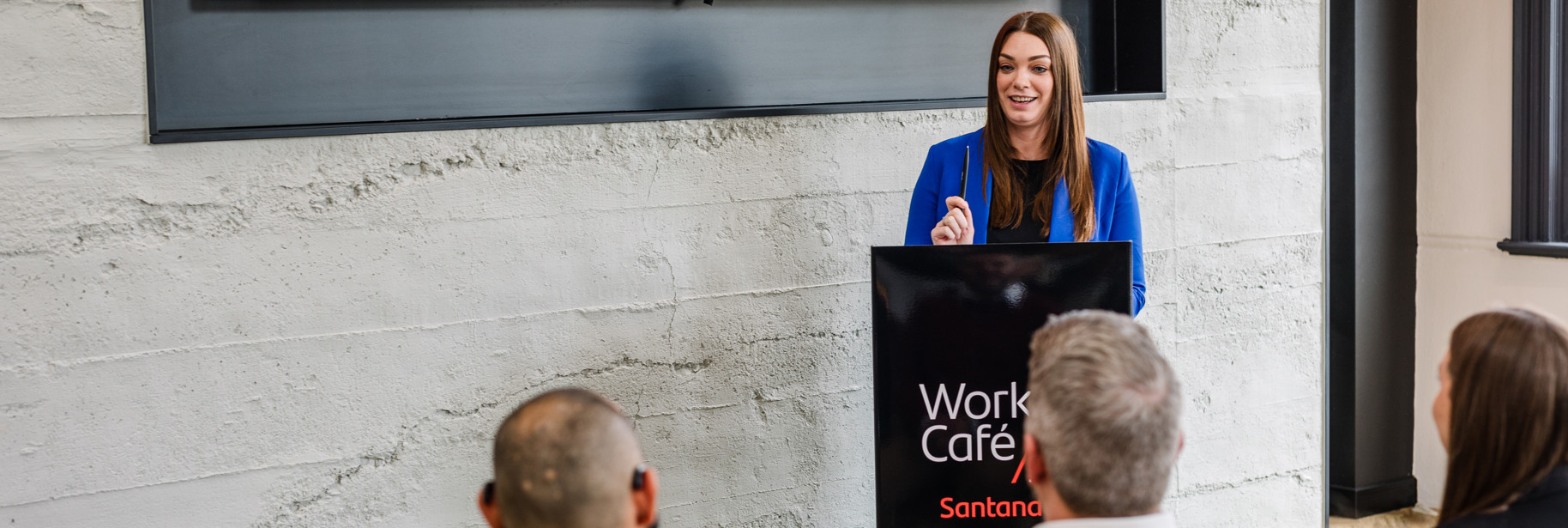 Lady presenting at lectern in IOM Work Cafe event space