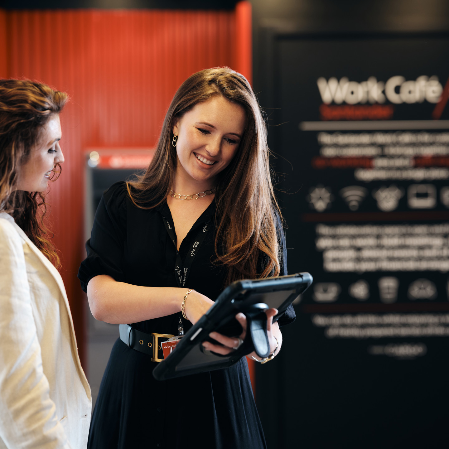 Jersey Work Cafe staff greeting customer with iPad