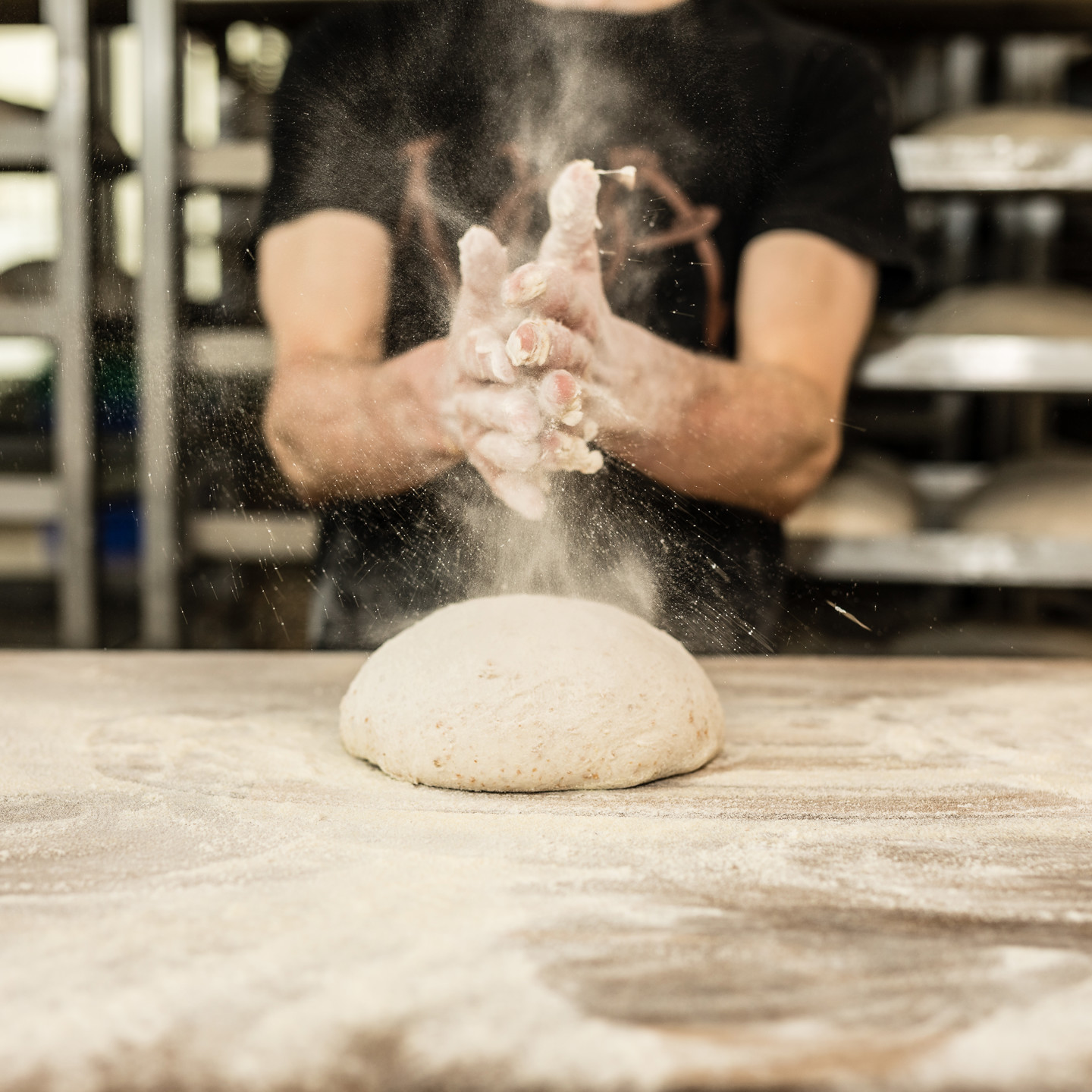 Dough being kneaded with floury hands