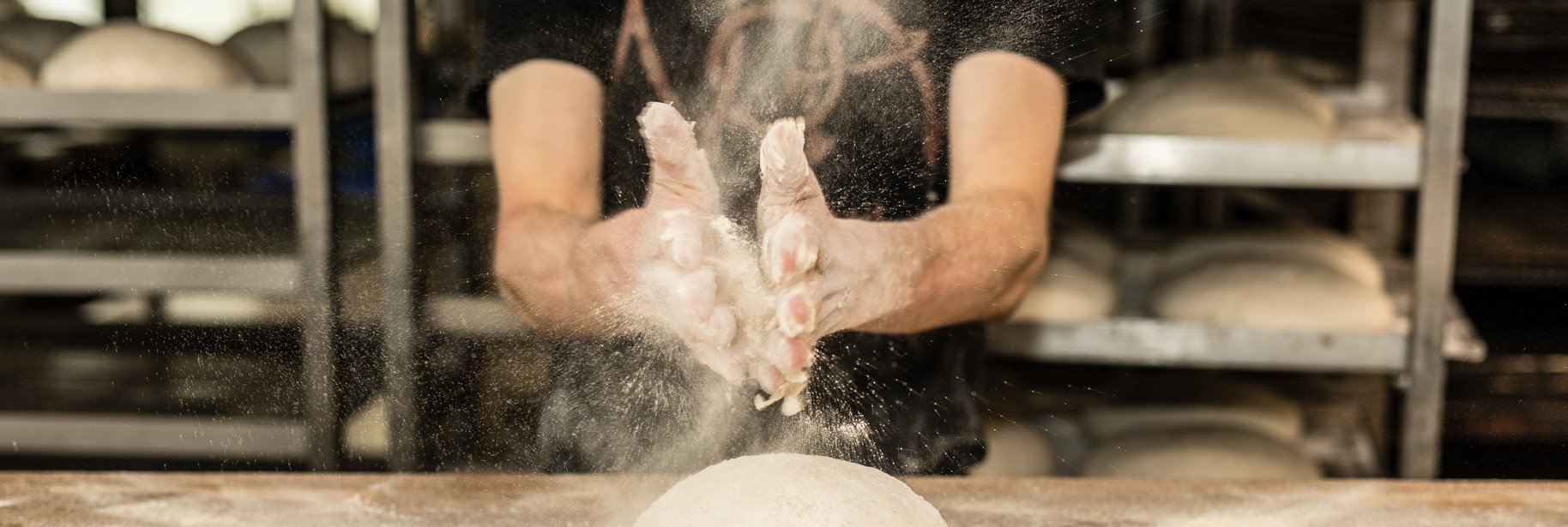 Dough being kneaded with floury hands