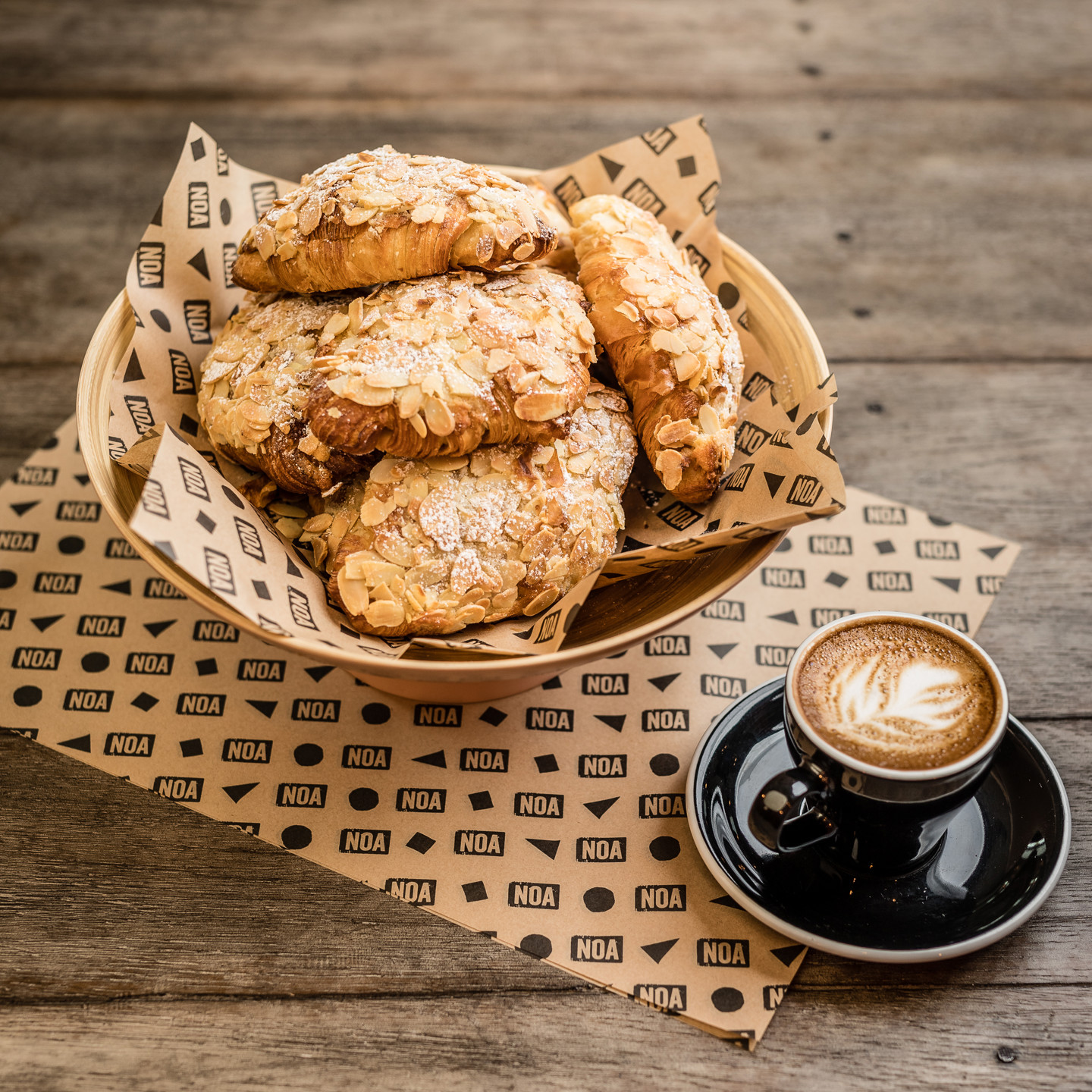 Bowl of almond croissants and cup of coffee