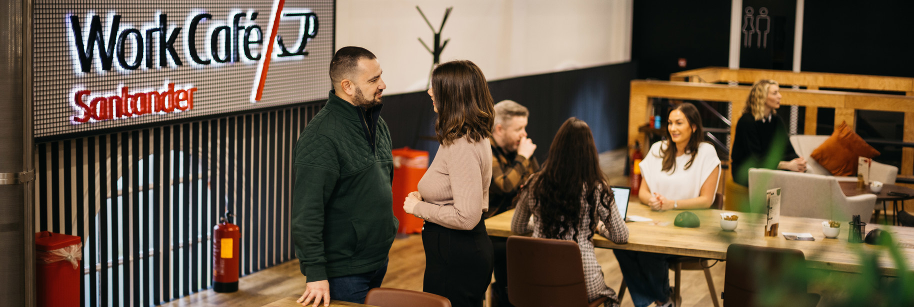 People chatting in IOM Work Cafe co-working space mezzanine level